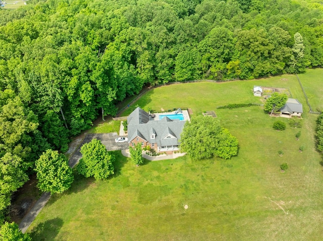 drone / aerial view featuring a wooded view