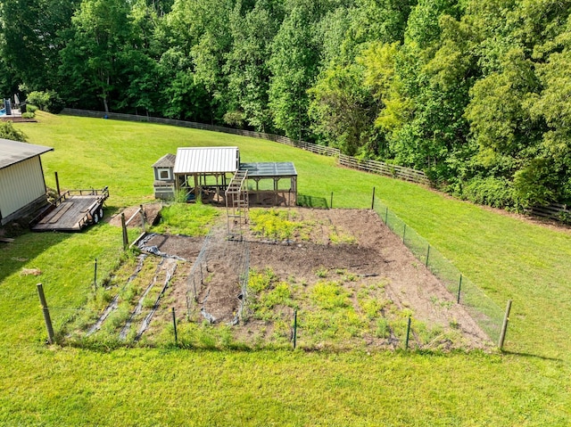 view of yard with fence and an outbuilding