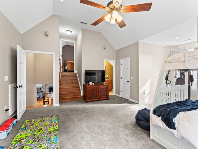 carpeted bedroom featuring baseboards, visible vents, a ceiling fan, and lofted ceiling