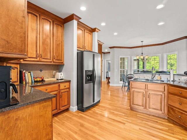 kitchen featuring a sink, stainless steel fridge with ice dispenser, and brown cabinets