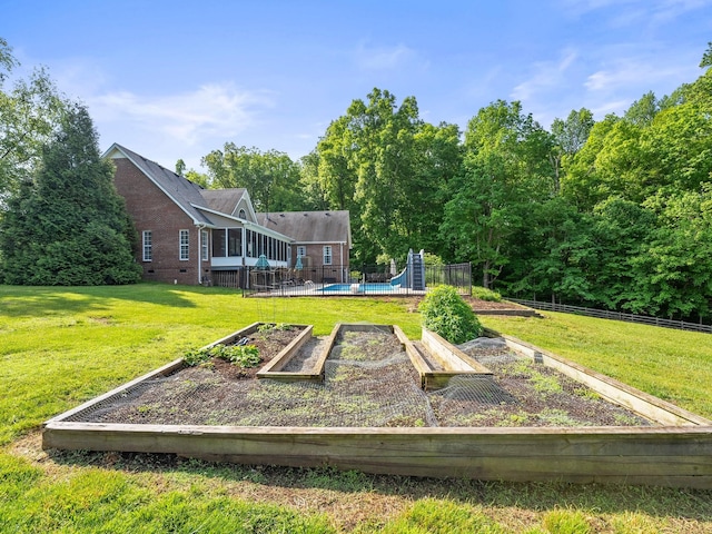 surrounding community featuring fence, a yard, and a vegetable garden