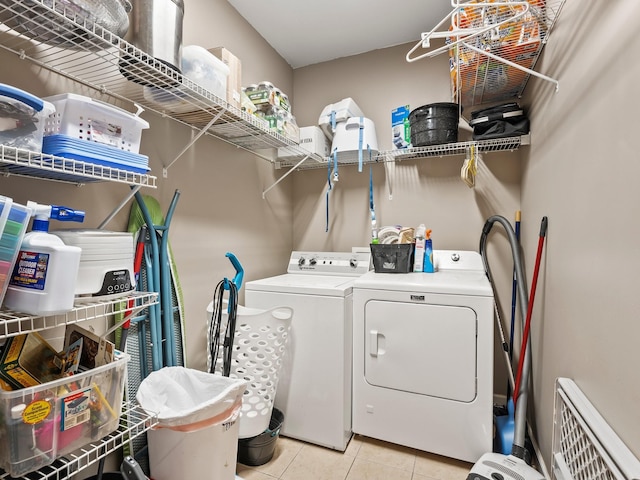 laundry area with light tile patterned floors, laundry area, and washer and clothes dryer