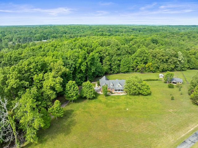 birds eye view of property featuring a view of trees