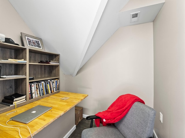 office with carpet floors, baseboards, visible vents, and lofted ceiling