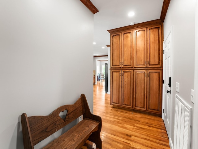 hall with light wood-style floors, recessed lighting, and visible vents