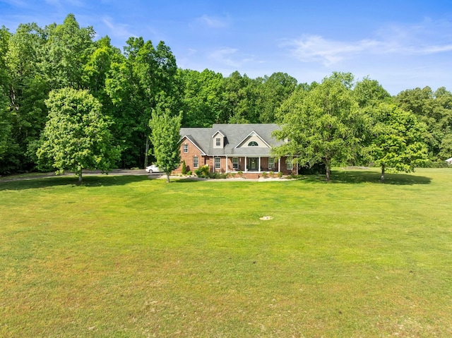 view of front facade with brick siding and a front lawn