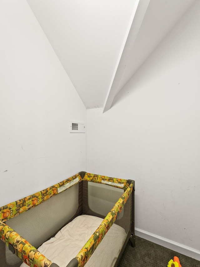 bedroom featuring baseboards, carpet flooring, lofted ceiling, and visible vents