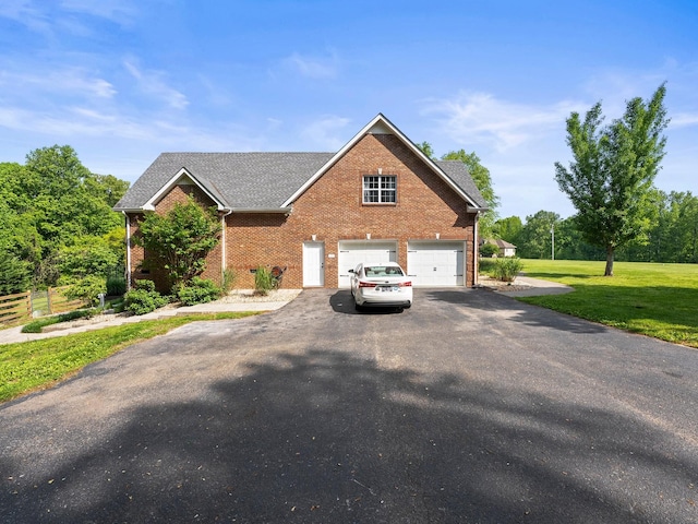view of front of house with a garage, a front lawn, aphalt driveway, roof with shingles, and brick siding