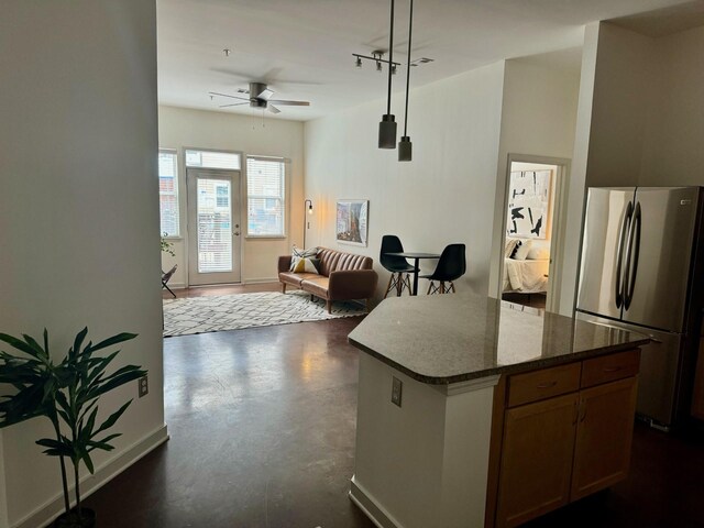 3000 Vanderbilt Pl Unit 118, Nashville, TN 37212 - kitchen with freestanding refrigerator, a kitchen island, open floor plan, finished concrete floors, and a ceiling fan