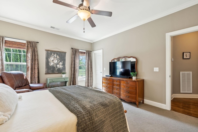 bedroom featuring visible vents, ornamental molding, and multiple windows