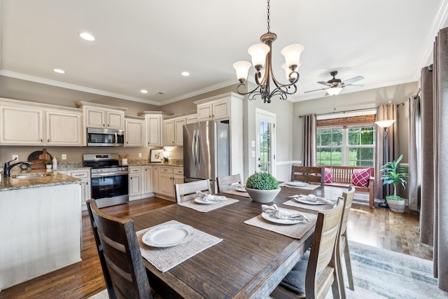 dining room with recessed lighting, ornamental molding, wood finished floors, and ceiling fan with notable chandelier