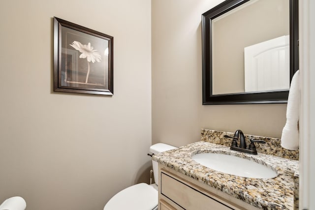 bathroom with vanity and toilet