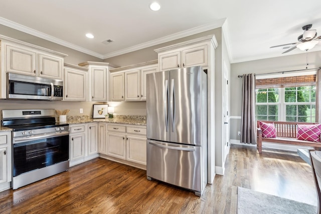 kitchen with crown molding, visible vents, light stone countertops, dark wood-type flooring, and appliances with stainless steel finishes