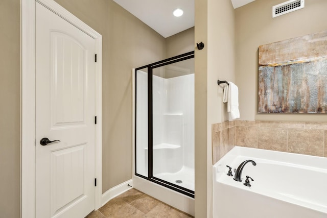 full bath featuring baseboards, visible vents, a bath, and a stall shower