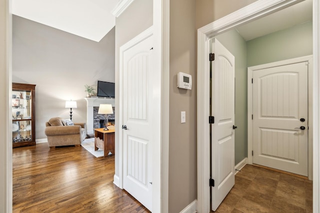 hall with baseboards and wood finished floors