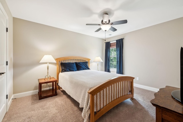 carpeted bedroom with baseboards and ceiling fan