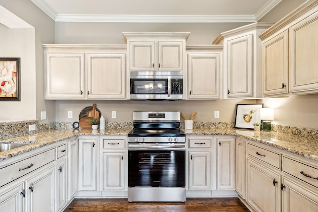 kitchen featuring crown molding, appliances with stainless steel finishes, and light stone counters