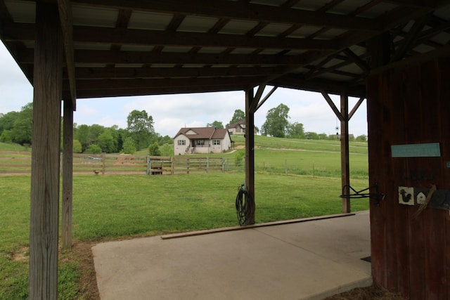 view of patio / terrace with fence and a rural view