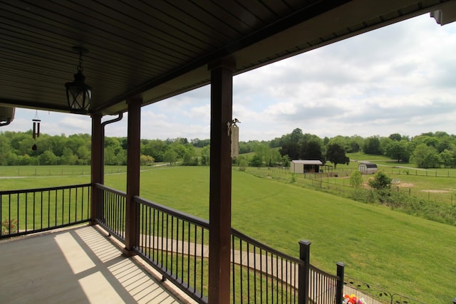 exterior space with a yard, a rural view, and fence