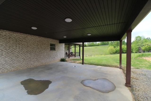 view of patio featuring fence and an attached carport