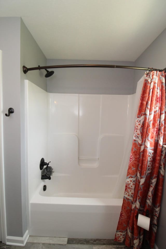 full bathroom featuring shower / bath combo with shower curtain and baseboards