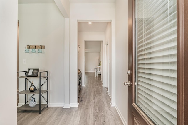 corridor featuring recessed lighting, baseboards, and light wood-type flooring