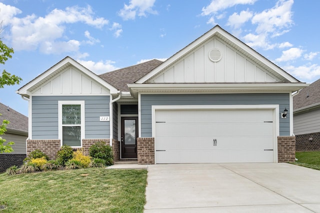 craftsman-style house with board and batten siding, driveway, a front yard, brick siding, and an attached garage