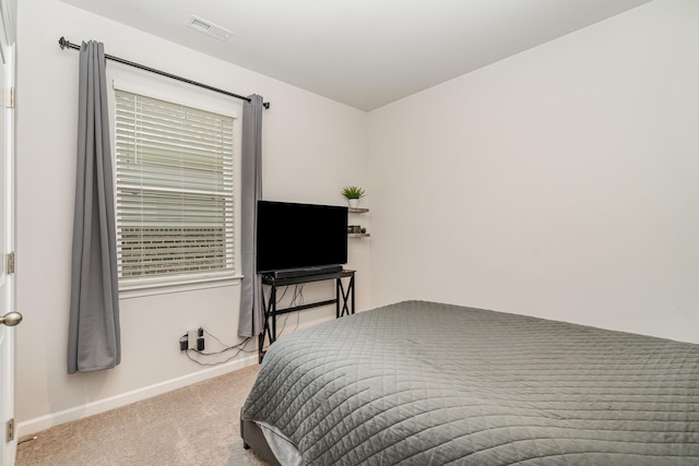 carpeted bedroom featuring baseboards and visible vents