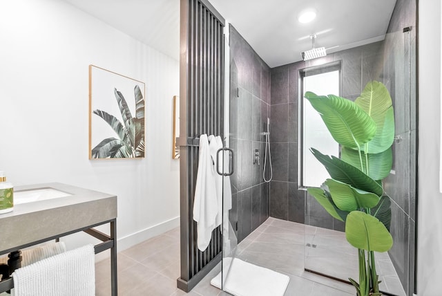 full bath with baseboards, tile patterned flooring, and a stall shower
