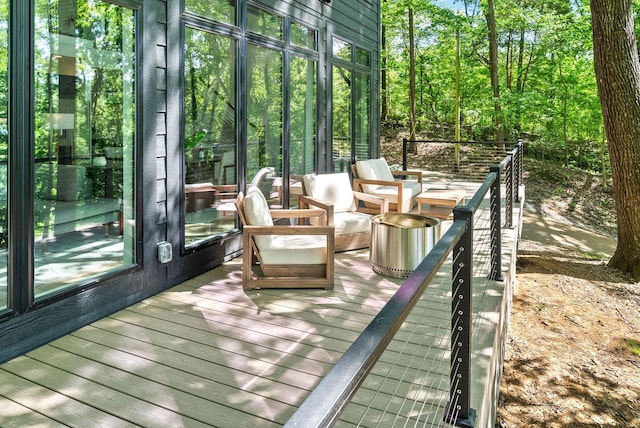 sunroom featuring a wooden deck and wood finished floors