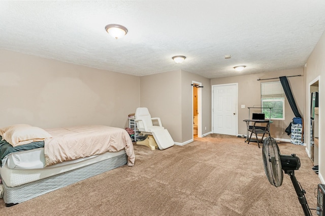 bedroom featuring a textured ceiling, light colored carpet, and baseboards