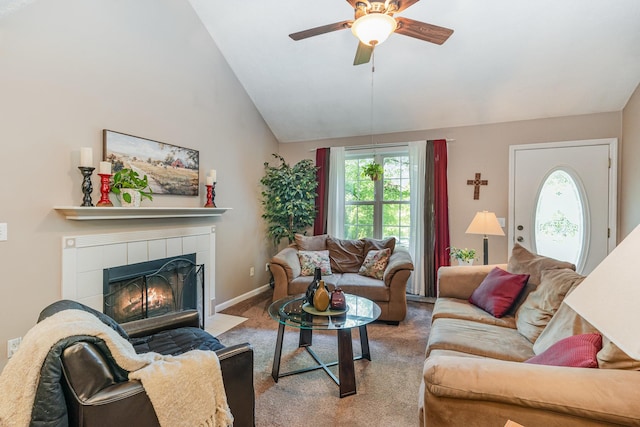 carpeted living room featuring a ceiling fan, high vaulted ceiling, plenty of natural light, and a tile fireplace