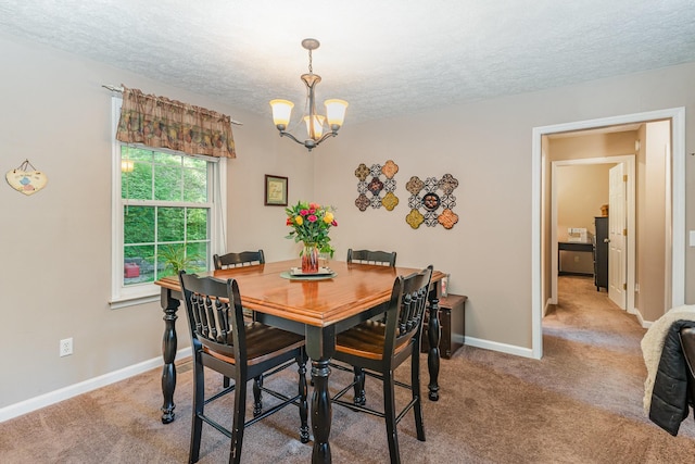 carpeted dining space with baseboards, a textured ceiling, and a notable chandelier