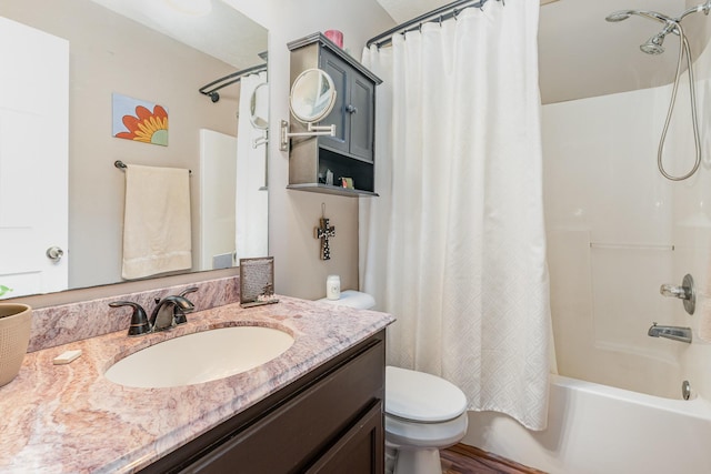 bathroom featuring vanity, shower / tub combo with curtain, and toilet