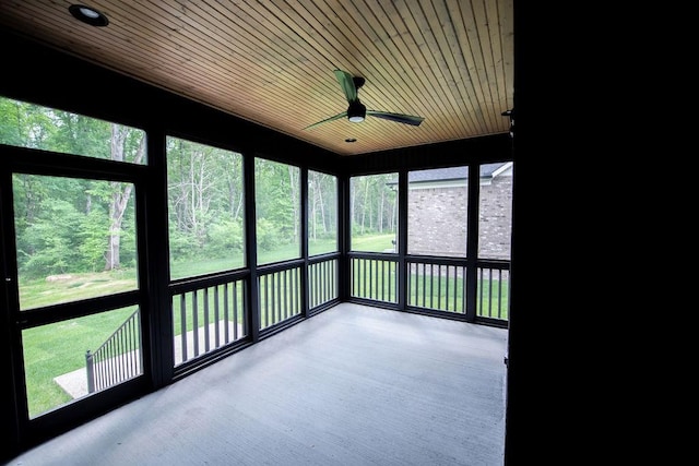 unfurnished sunroom featuring a ceiling fan
