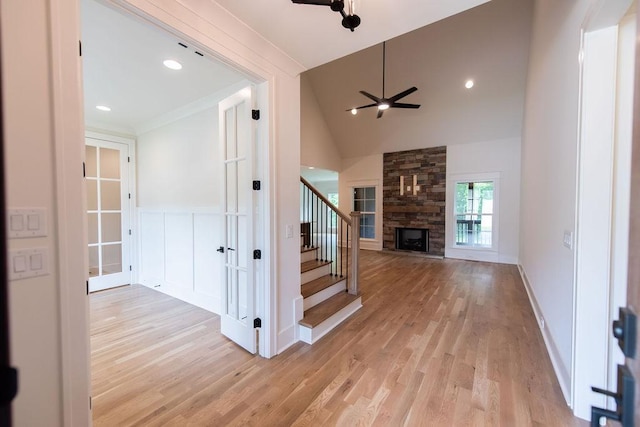 interior space featuring ceiling fan, vaulted ceiling, wood finished floors, and a fireplace
