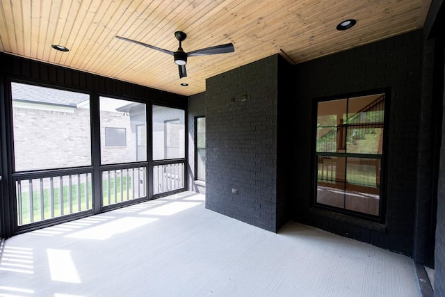 unfurnished sunroom featuring a healthy amount of sunlight and a ceiling fan