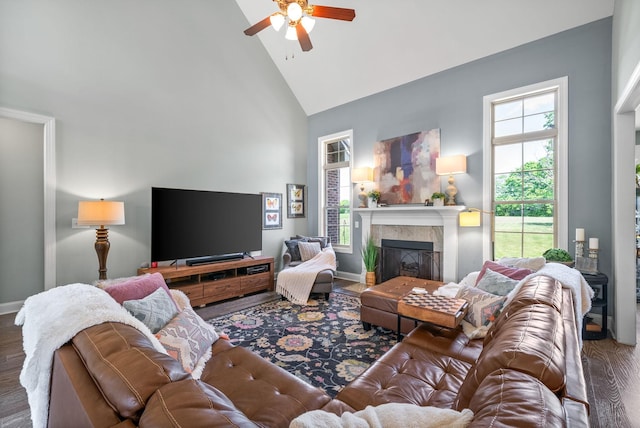 1005 Felts Dr, Clarksville, TN 37043 - living area featuring wood finished floors, baseboards, ceiling fan, high vaulted ceiling, and a tile fireplace