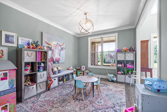 1005 Felts Dr, Clarksville, TN 37043 - playroom featuring crown molding, baseboards, wood finished floors, and a chandelier
