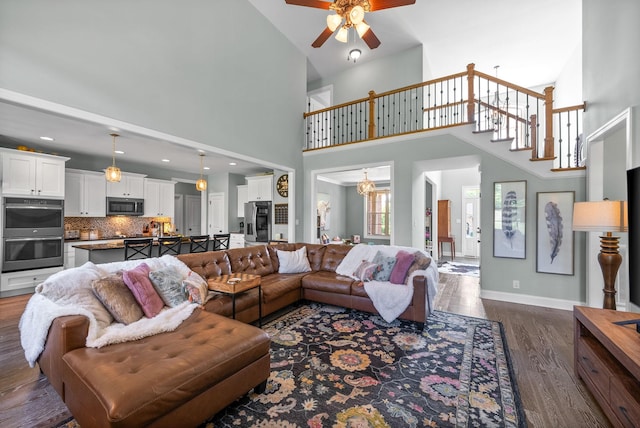 1005 Felts Dr, Clarksville, TN 37043 - living area with ceiling fan, a towering ceiling, dark wood finished floors, baseboards, and stairs