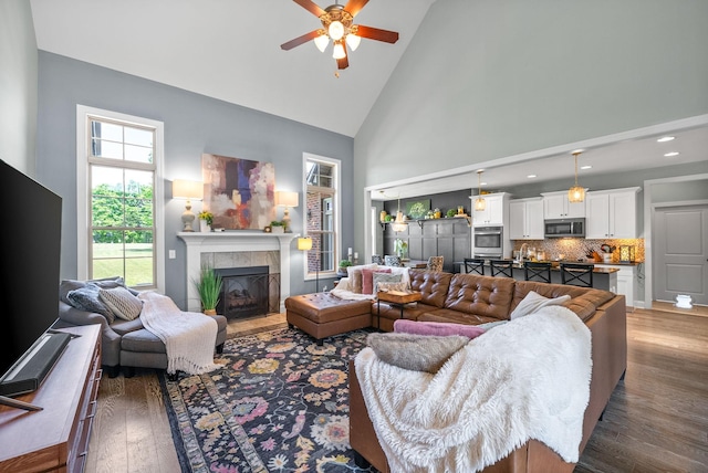 1005 Felts Dr, Clarksville, TN 37043 - living area featuring wood-type flooring, high vaulted ceiling, recessed lighting, a tile fireplace, and a ceiling fan