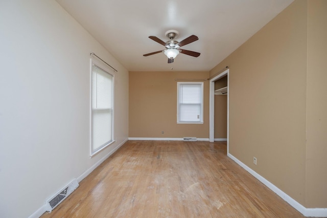 unfurnished bedroom with visible vents, baseboards, and multiple windows