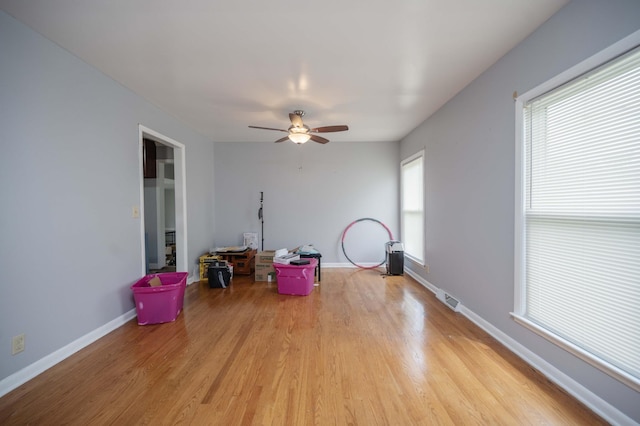 game room featuring ceiling fan, visible vents, baseboards, and light wood-style floors