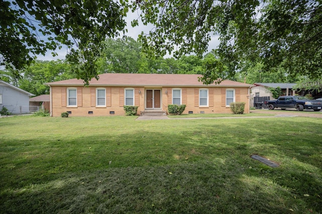 ranch-style house featuring brick siding, crawl space, fence, and a front lawn