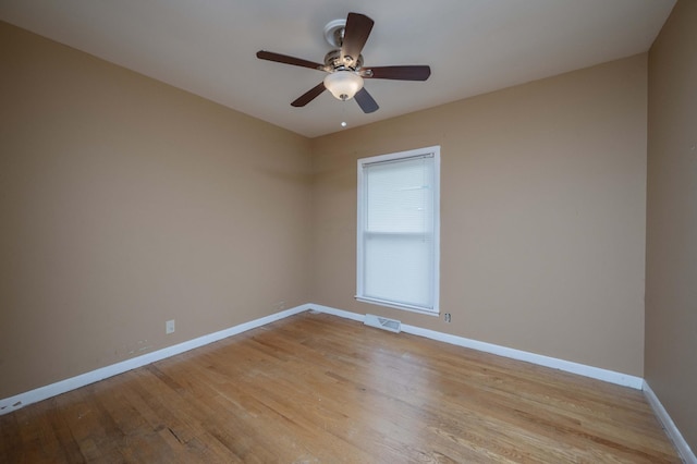 unfurnished room with visible vents, a ceiling fan, baseboards, and light wood-style floors