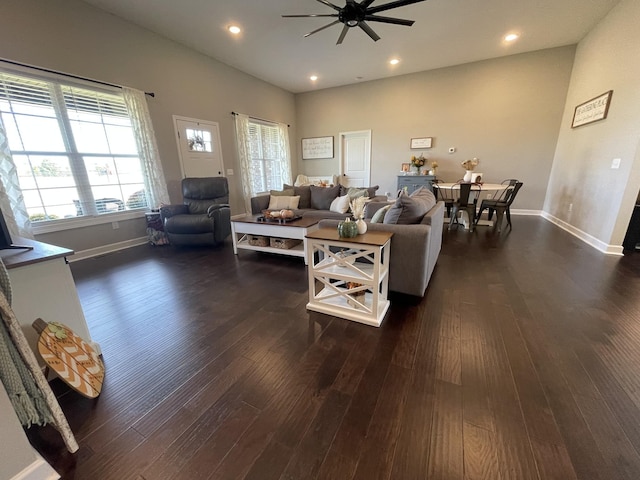 living area featuring baseboards, a ceiling fan, dark wood-style flooring, and recessed lighting