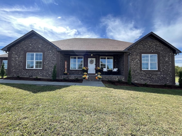 single story home with brick siding, a shingled roof, a front lawn, and covered porch