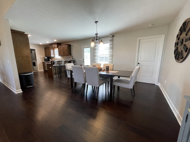 dining area featuring baseboards, recessed lighting, dark wood-type flooring, and a notable chandelier