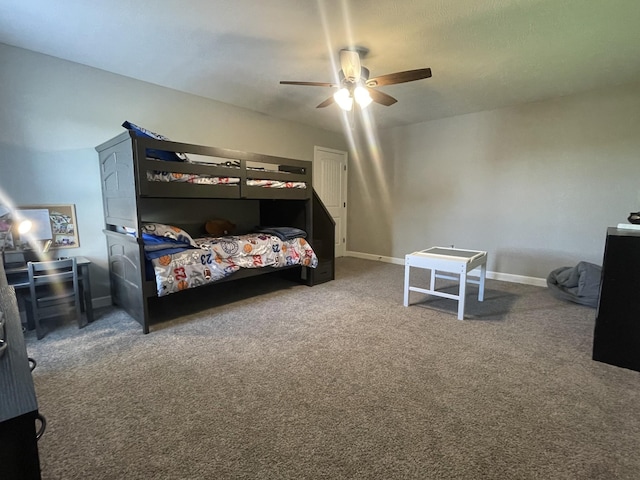 carpeted bedroom with baseboards and a ceiling fan