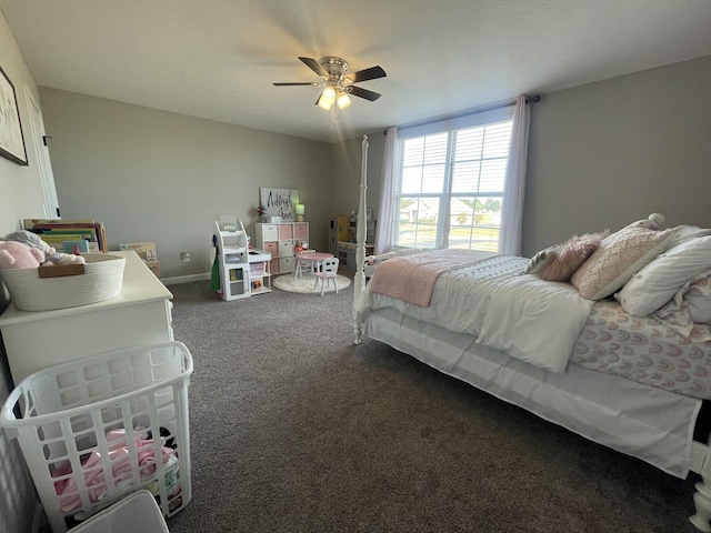 bedroom featuring a ceiling fan and dark carpet